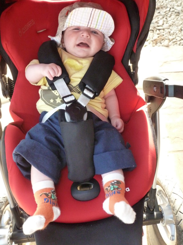 crying baby in pushchair