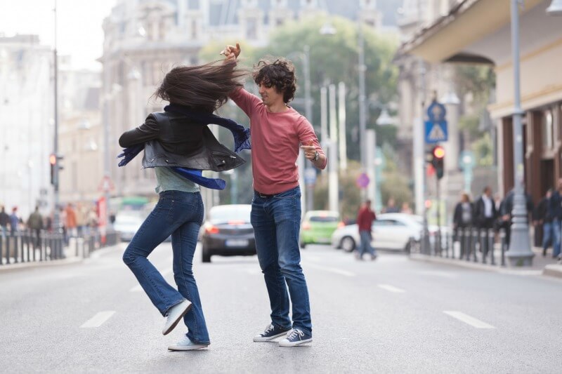 couple dancing in the street wearing casual wear