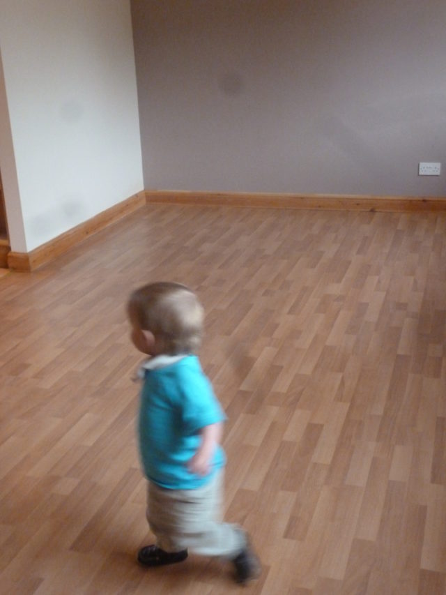 toddler walking around empty floor