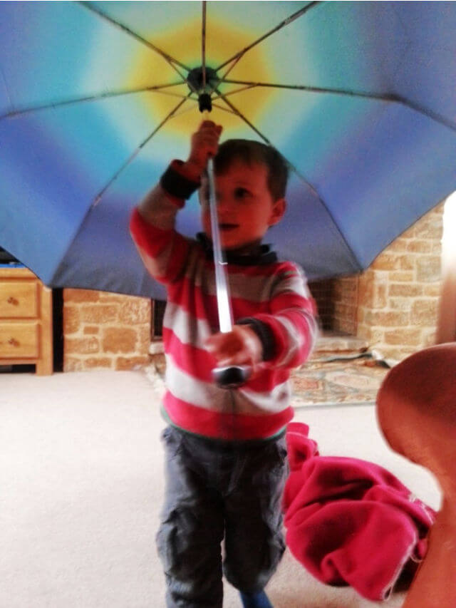 toddler playing with open ombre colour umbrella (1)