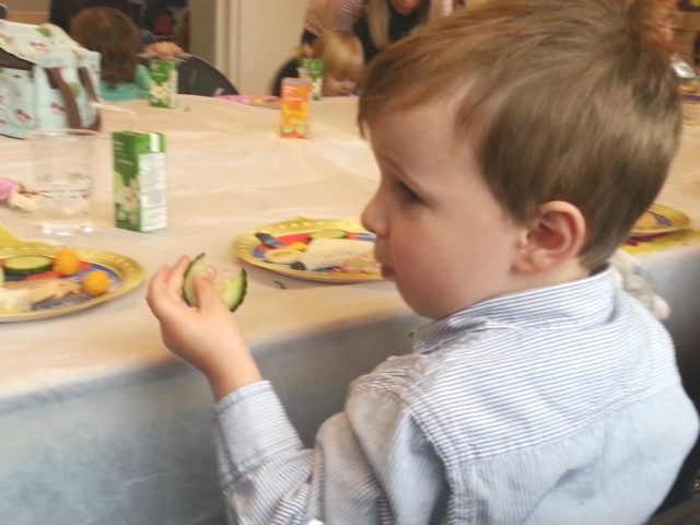 toddler eating birthday tea