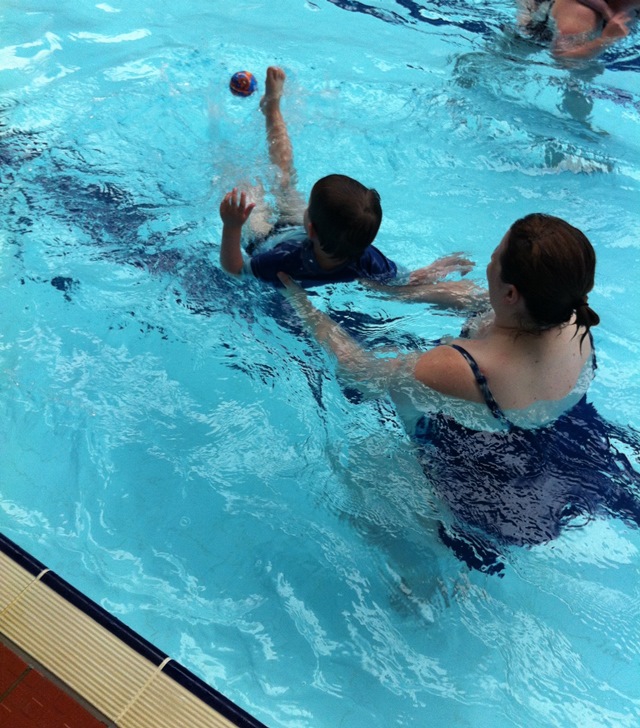 practising swimming on his back and kicking