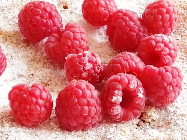raspberries atop a cake