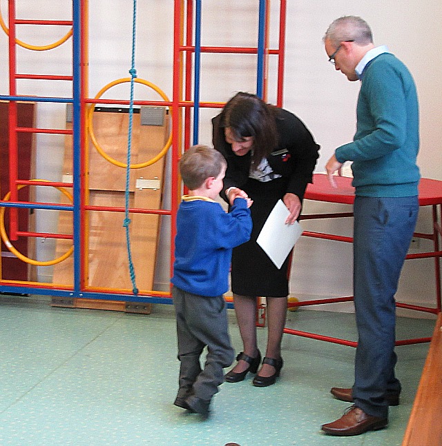 Receiving his target certificate in assembly