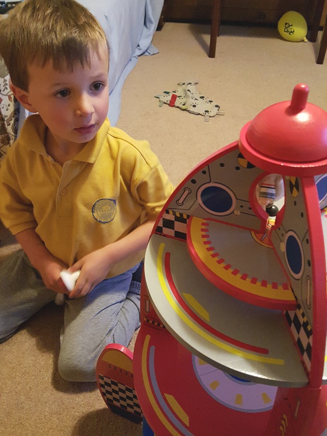 putting the pieces on the rocket toy