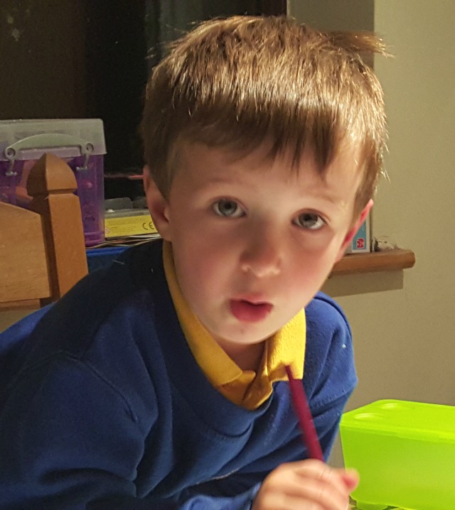 practising writing his name