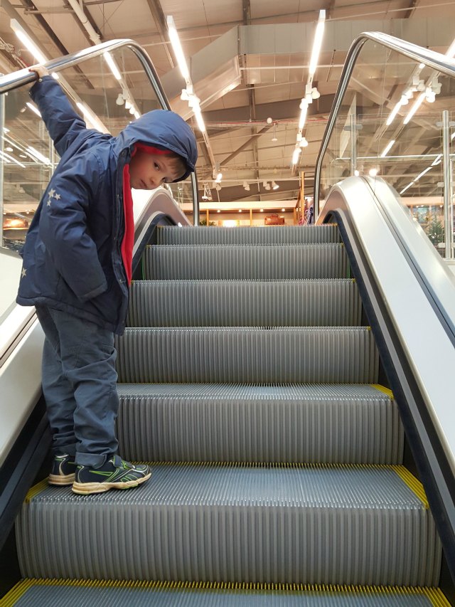 riding the escalator in Marks and Spencer