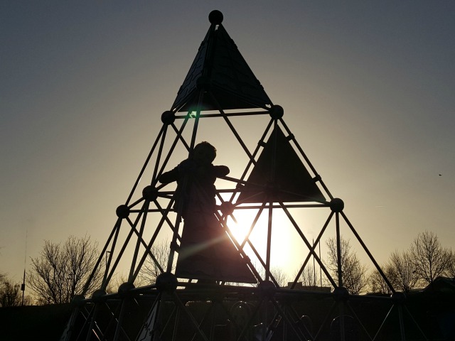 morning sunlight through a climbing frame silhouette