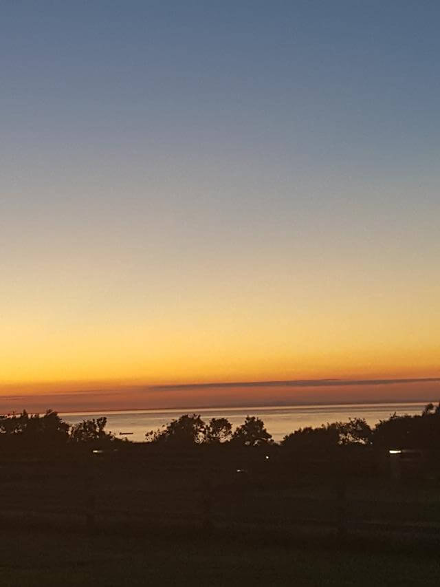 sunset over warcombe farm campsite in Devon