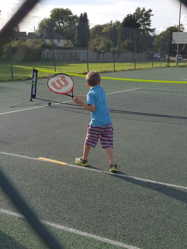 playing tennis at club