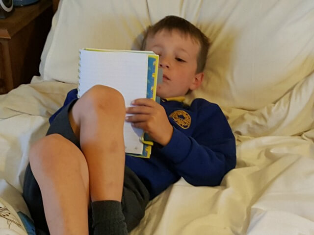 writing in his notebook