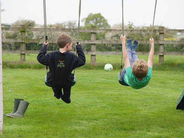 cousins on swings