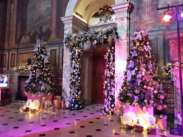 Blenheim palace hall decorated for christmas with 2 trees
