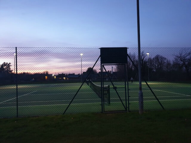 tennis courts under floodlighting