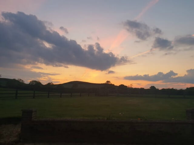 sunset over the farm hills