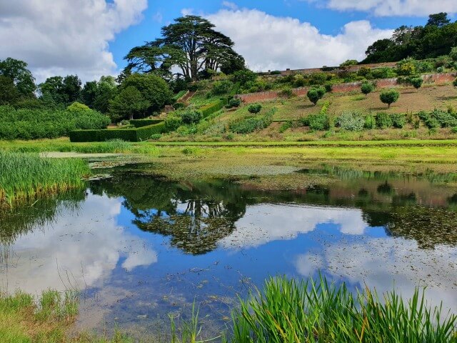 reflection of sky and trees in the mirror lake at Upton House