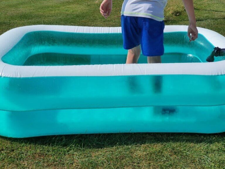 Paddling pool fun for dog and boy