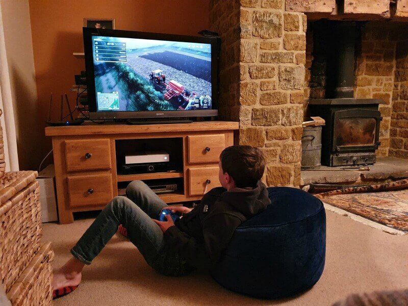 comfy on the floor playing farming simulator