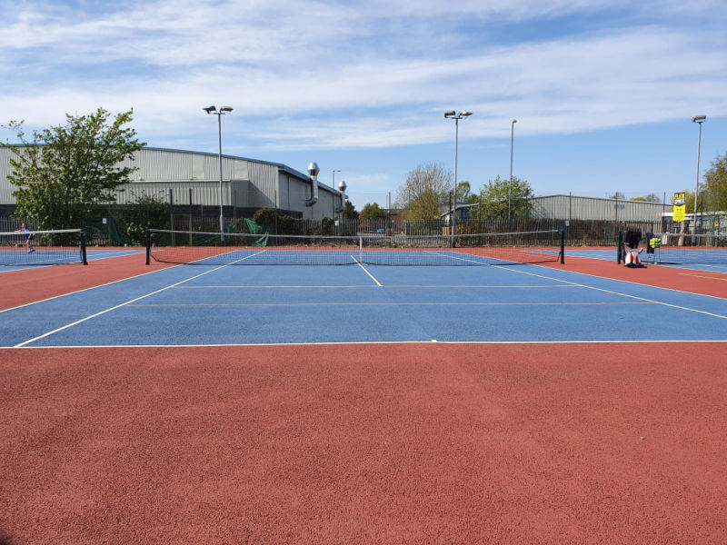 red and blue macadam tennis court from front view