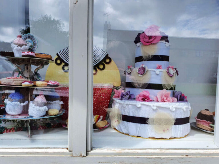 Yarn crafts in window at village shop