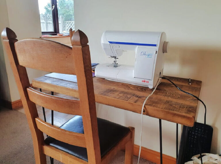 wooden industrial style desk with sewing machine on