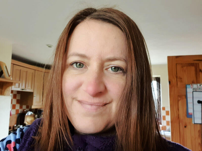 woman with medium bob dyed warm brown, but looks red
