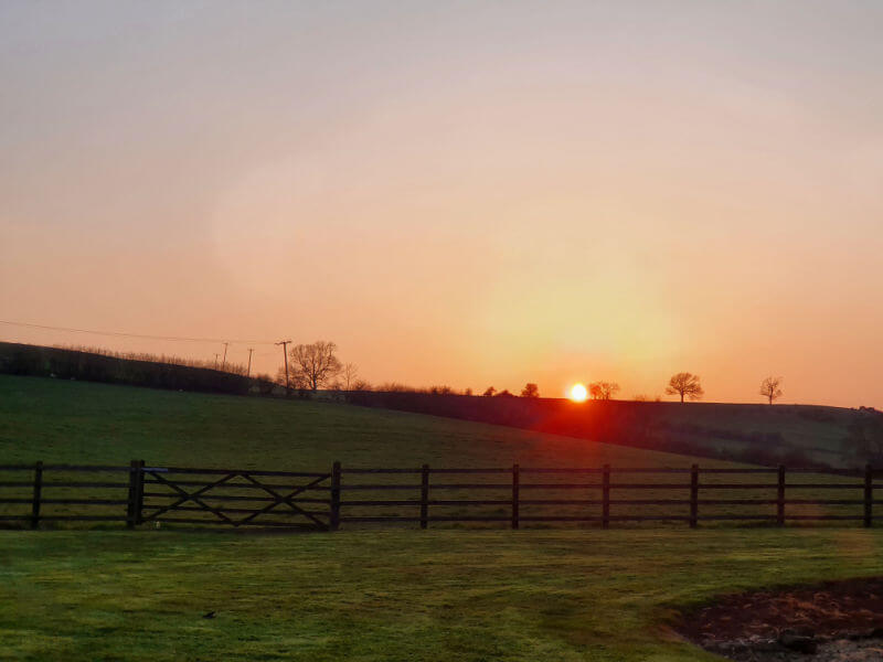 orange sunset over fields