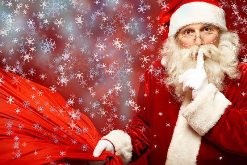 Santa with finger to his lips to shush someone