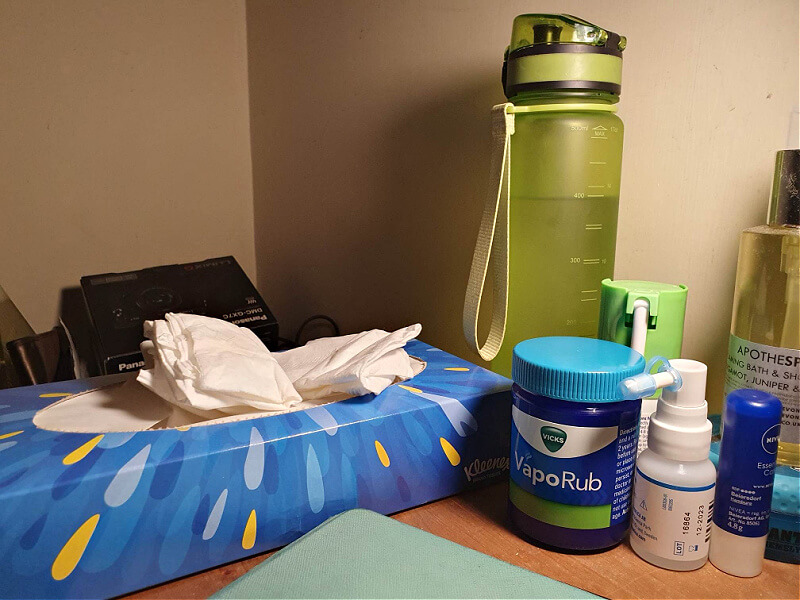 bedside table with water and cold remedies