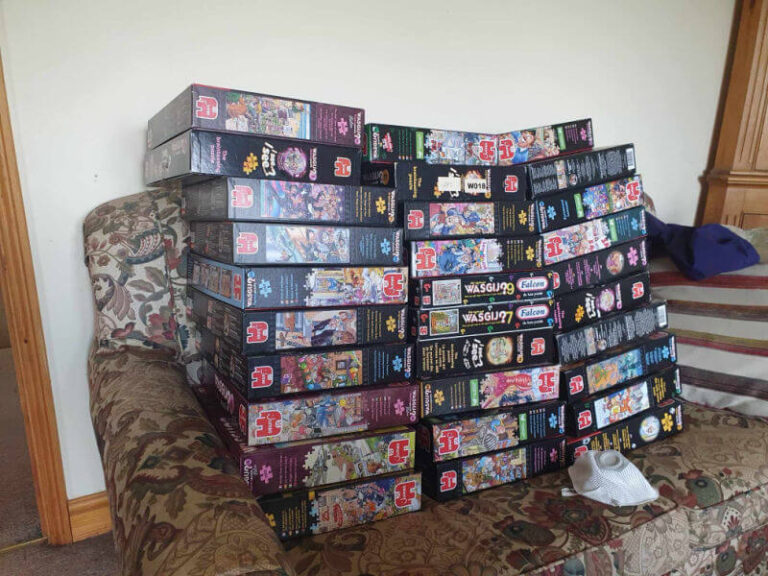 piles of wasgij puzzle boxes