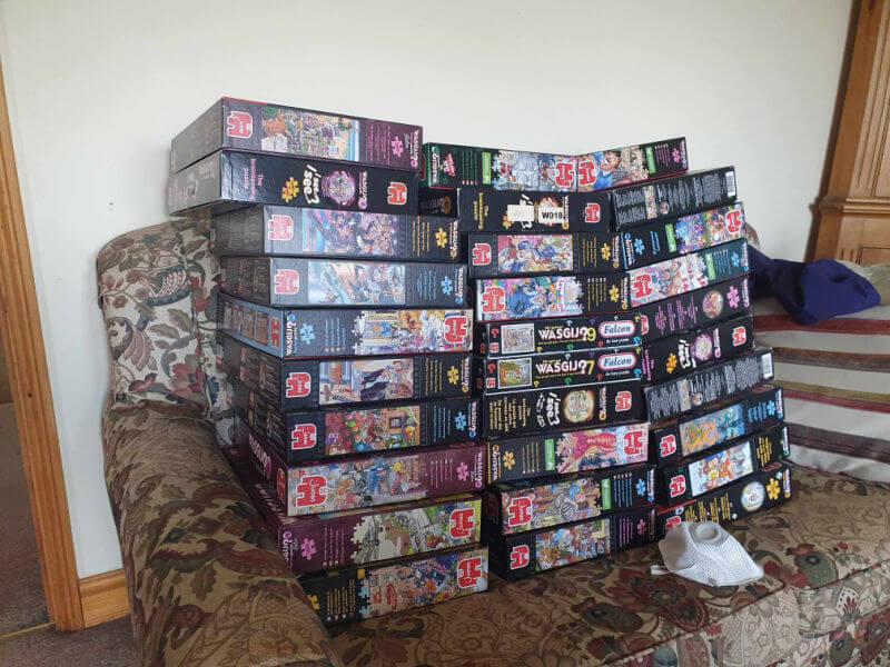 piles of wasgij puzzle boxes
