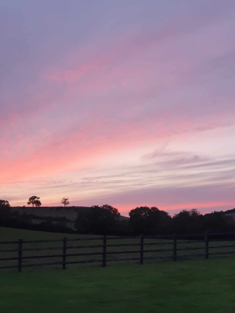sunset across the hills and fields