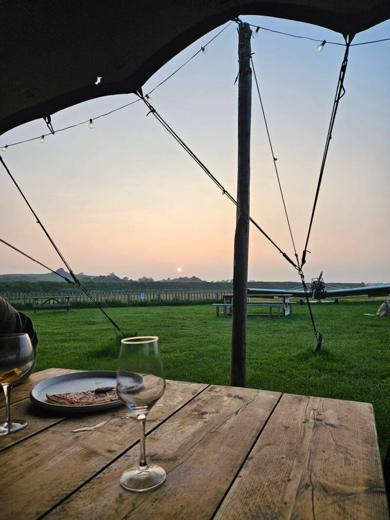 looking out under canopy table and drinks towards sunset