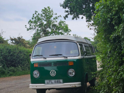 green VW campervan parked on verge