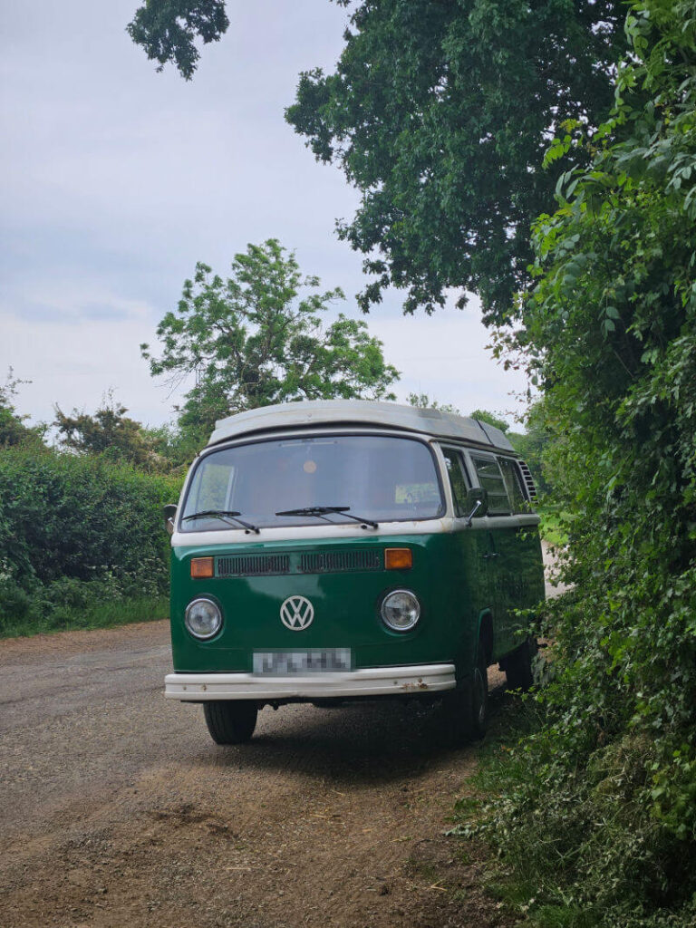 green VW campervan parked on verge